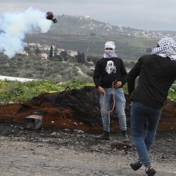 Los manifestantes palestinos usan honda para lanzar piedras en medio de enfrentamientos con las tropas israelíes en la aldea de Kfar Qaddum cerca del asentamiento judío de Qadumim (Kedumim) en la ocupada Cisjordania, durante una manifestación contra la expropiación de tierras por parte de Israel. | Foto:Jaafar Ashtiyeh / AFP