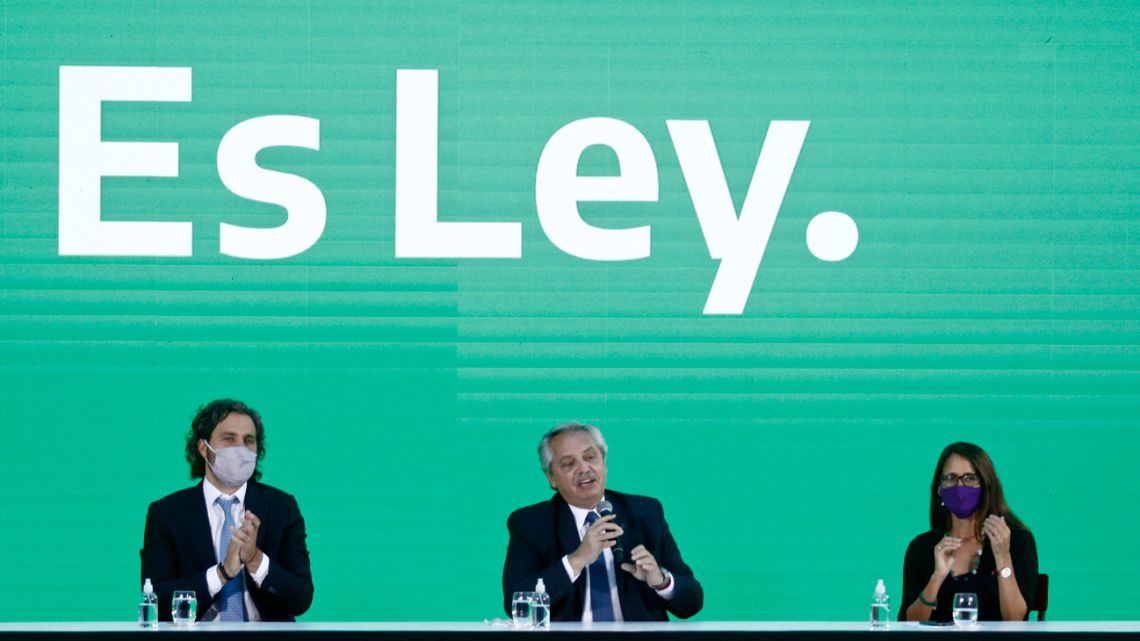 President Alberto Fernandez (C), speaks next to Cabinet Chief Santiago Cafiero (L) and the Minister of Women, Genders and Diversity, Elizabeth Gomez Alcorta, during the promulgation ceremony of the abortion law known as Voluntary Interruption of Pregnancy Law (IVE in Spanish) in Buenos Aires, on January 14, 2021. Fernandez sign the law that allows voluntary terminations up to 14 weeks of pregnancy, which was passed by the senate on December 30, 2020. 