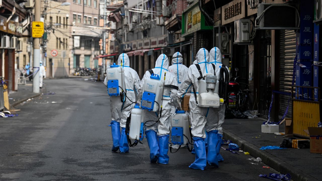 Los trabajadores de la salud con equipo de protección se preparan para rociar desinfectante en un área bloqueada en el distrito de Huangpu de Shanghai, luego de que los residentes fueran evacuados tras la detección de algunos casos de coronavirus COVID-19 en el vecindario. | Foto:STR / AFP