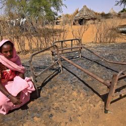 Una mujer sudanesa es fotografiada junto a camas quemadas luego de la violencia en la aldea de al-Taweel Saadun, 85 kilómetros al sur de la ciudad de Nyala, la capital de Darfur del Sur. | Foto:Ashraf Shazly / AFP