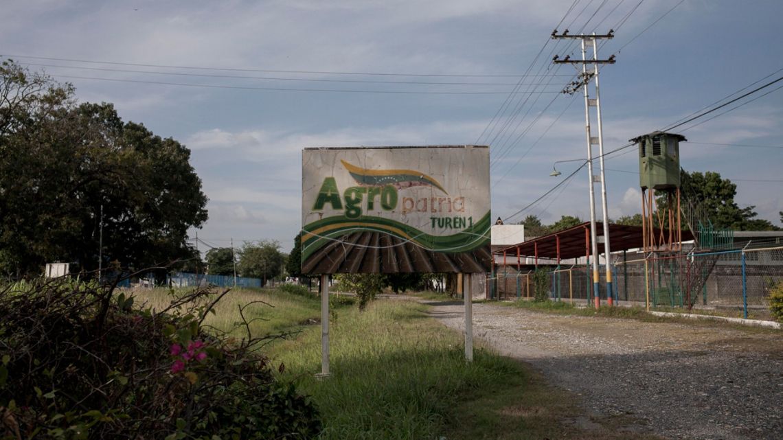 Signage stands outside the state-owned Agropatria agricultural supply store in the town of Turen, Portuguesa state, Venezuela, on Saturday, November 11, 2017. In western Portuguesa state, which was the nation's breadbasket, hundreds of arable acres were lost after seeds didn't arrive until the rainy season. As Venezuelans in cities scavenge for food, once-fertile farmlands are barren as well.
