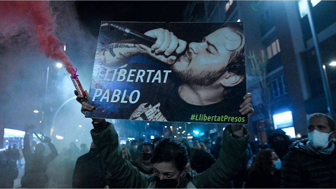 Protesters march with a picture of Spanish rapper Pablo Hasel reading 