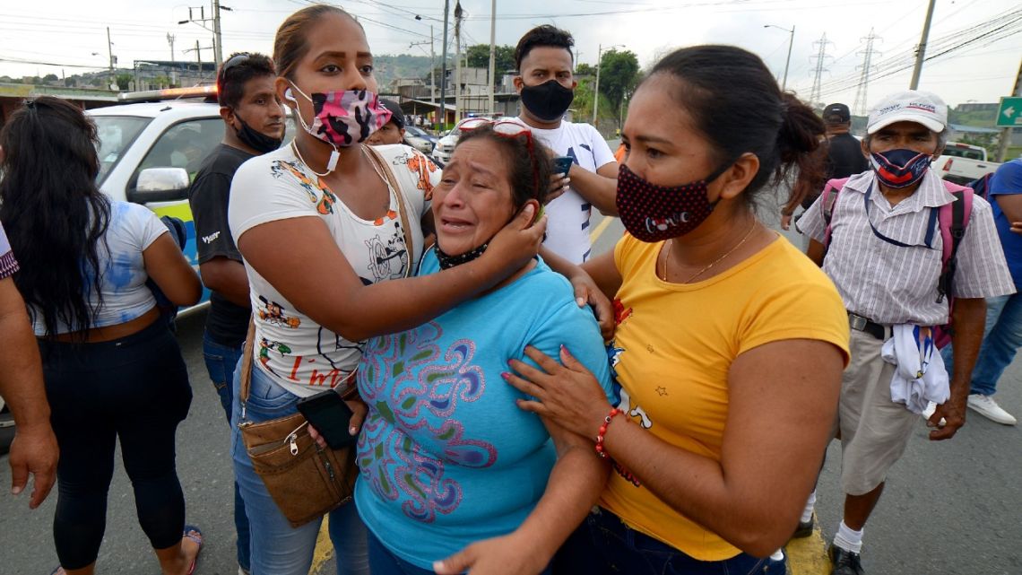 Relatives of the prisoners at the Zone 8 Deprivation of Liberty Center are seen as they wait for news, in Guayaquil, Ecuador, on February 23, 2021. 