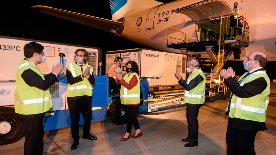 Officials applaud after the arrival of an Aerolíneas Argentinas plane carrying more than 900,000 doses of the Chinese laboratory Sinopharm's coronavirus vaccine, at Ezeiza international airport.