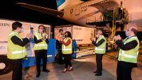 Officials applaud after the arrival of an Aerolíneas Argentinas plane carrying more than 900,000 doses of the Chinese laboratory Sinopharm's coronavirus vaccine, at Ezeiza international airport.