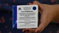 A health worker holds a box with five doses of the Sputnik V vaccine against Covid-19, before vaccination health and education workers in a school in Bernal on February 18, 2021.