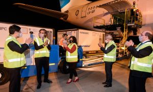Officials applaud after the arrival of an Aerolíneas Argentinas plane carrying more than 900,000 doses of the Chinese laboratory Sinopharm's coronavirus vaccine, at Ezeiza international airport.
