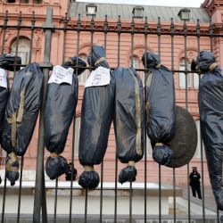 Mock body bags displayed by demonstrators are seen in front of the Casa Rosada in Buenos Aires, on February 27, 2021, during a protest against the government of President Alberto Fernández over the VIP vaccination scandal.
