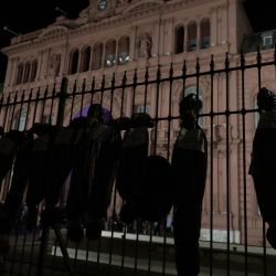 Mock body bags displayed by demonstrators are seen in front of the Casa Rosada in Buenos Aires, on February 27, 2021, during a protest against the government of President Alberto Fernández over the VIP vaccination scandal.