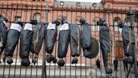 Mock body bags displayed by demonstrators are seen in front of the Casa Rosada in Buenos Aires, on February 27, 2021, during a protest against the government of President Alberto Fernández over the VIP vaccination scandal.