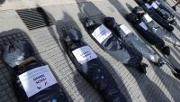 Mock body bags displayed by demonstrators are seen in front of the Casa Rosada in Buenos Aires, on February 27, 2021, during a protest against the government of President Alberto Fernández over the VIP vaccination scandal.
