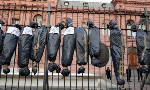 Mock body bags displayed by demonstrators are seen in front of the Casa Rosada in Buenos Aires, on February 27, 2021, during a protest against the government of President Alberto Fernández over the VIP vaccination scandal.