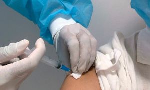 A teacher is inoculated with the CoronaVac vaccine, developed by China's Sinovac laboratory, against the novel coronavirus disease, COVID-19, in Montevideo on March 1, 2021.