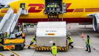 Handout picture released by the Colombian Presidency shows airport workers unloading 117,000 doses of vaccines against Covid-19 delivered through the Covax mechanism, at El Dorado airport international in Bogota on March 1, 2021.