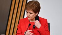 Scotland's First Minister Nicola Sturgeon removes her face covering as she arrives to give evidence to The Committee on the Scottish Government Handling of Harassment Complaints at Holyrood in Edinburgh, examining the government's handling of harassment allegations against former Scottish National Party leader and former first minister of Scotland, Alex Salmond on March 3, 2021.