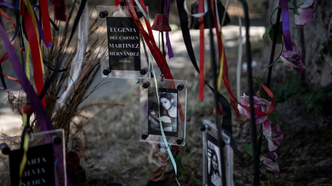View of pictures of female victims of Augusto Pinochet's regime at an altar outside the Venda Sexy former clandestine detention centre, in Santiago, on November 21, 2020. 
