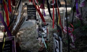 View of pictures of female victims of Augusto Pinochet's regime at an altar outside the Venda Sexy former clandestine detention centre, in Santiago, on November 21, 2020.