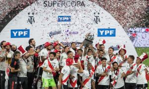 River Plate's players and coaching staff celebrate their win.
