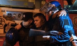 An injured policeman is helped by colleagues during confrontations with demonstrators following a protest against corruption and lacks in the health system, demanding the resignation of Paraguayan President Mario Abdo Benítez, in Asunción, on March 5, 2021.