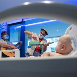 Payasos de la ONG Sunrise Media (Medical Smile) actúan para un bebé en el ala infantil del Hospital Son Espases de Palma de Mallorca. | Foto:Jaime Reina / AFP