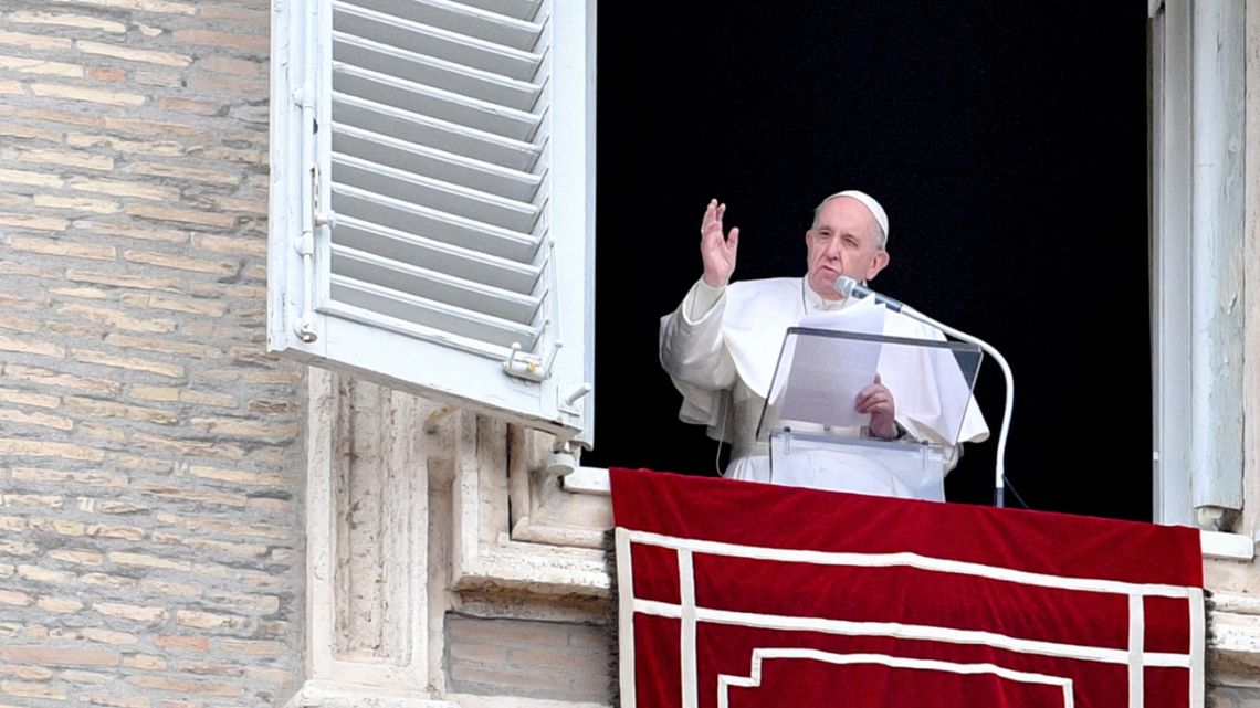 Pope Francis addresses attendees from the window of the apostolic palace overlooking St. Peter's Square during the weekly Angelus prayer on March 14, 2021 in The Vatican.