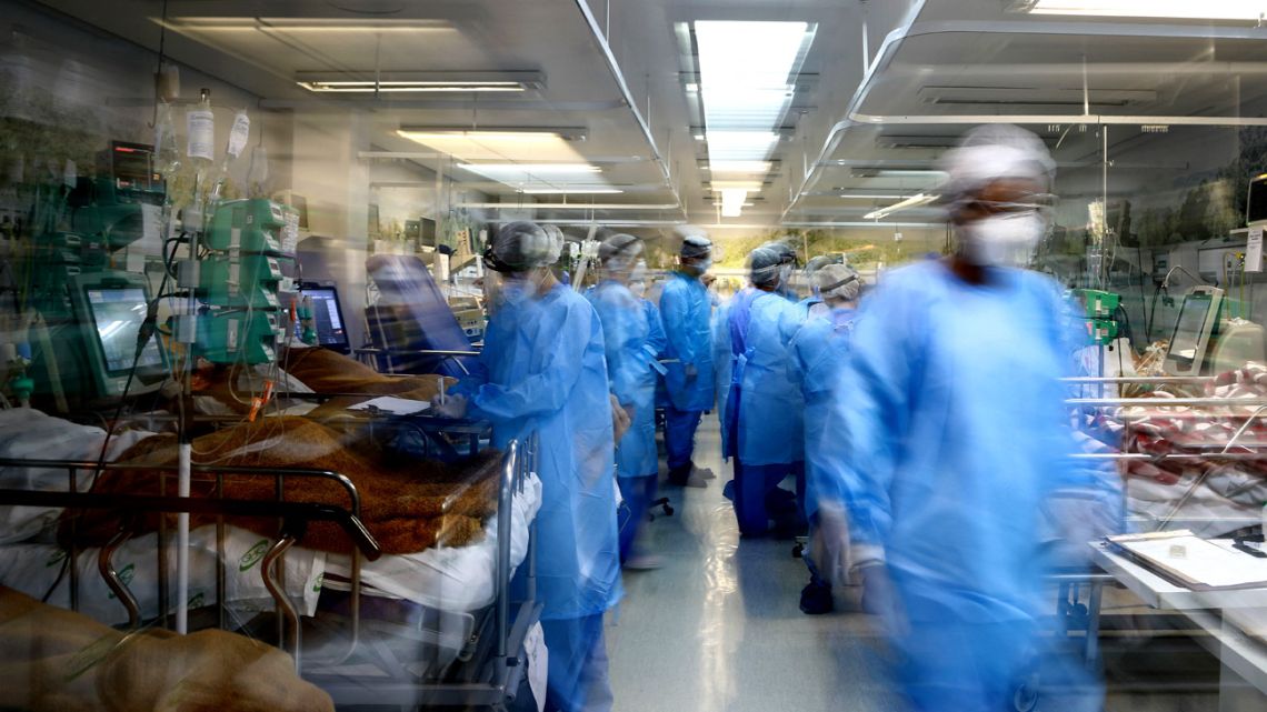 Healthcare workers look after patients infected with Covid-19 at the full emergency room of the Nossa Senhora da Conceição hospital in Porto Alegre, Rio Grande do Sul State, in southern Brazil, on March 11, 2021, amid the novel coronavirus pandemic. 