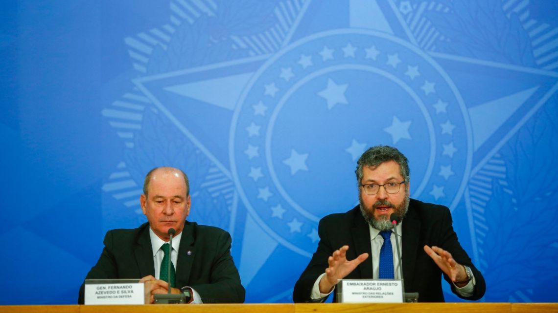 In this file photo taken on February 4, 2020 Foreign Minister Ernesto Araujo (R) speaks next to Defense Minister Fernando Azevedo e Silva during a press conference regarding the evacuation of Brazilian citizens from Wuhan --the region affected by the coronavirus in China-- at the Planalto Palace, Brasilia. Brazilian Defence Minister Fernando Azevedo e Silva announced his exit from far-right President Jair Bolsonaro's administration on March 29, 2021, following on the heels of the foreign and health ministers. His announcement came hours after Foreign Minister Ernesto Araujo submitted his resignation amid controversy over the government's problems securing more COVID-19 vaccines. 