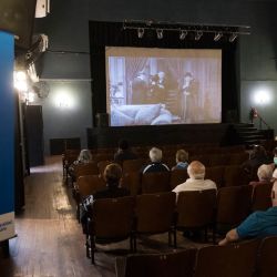 At the Cine Lumière Cultural Centre in Rosario, Santa Fe Province, elderly citizens wait to be vaccinated with the Sputnik V jab against Covid-19 while Charles Chaplin's movies are projected.