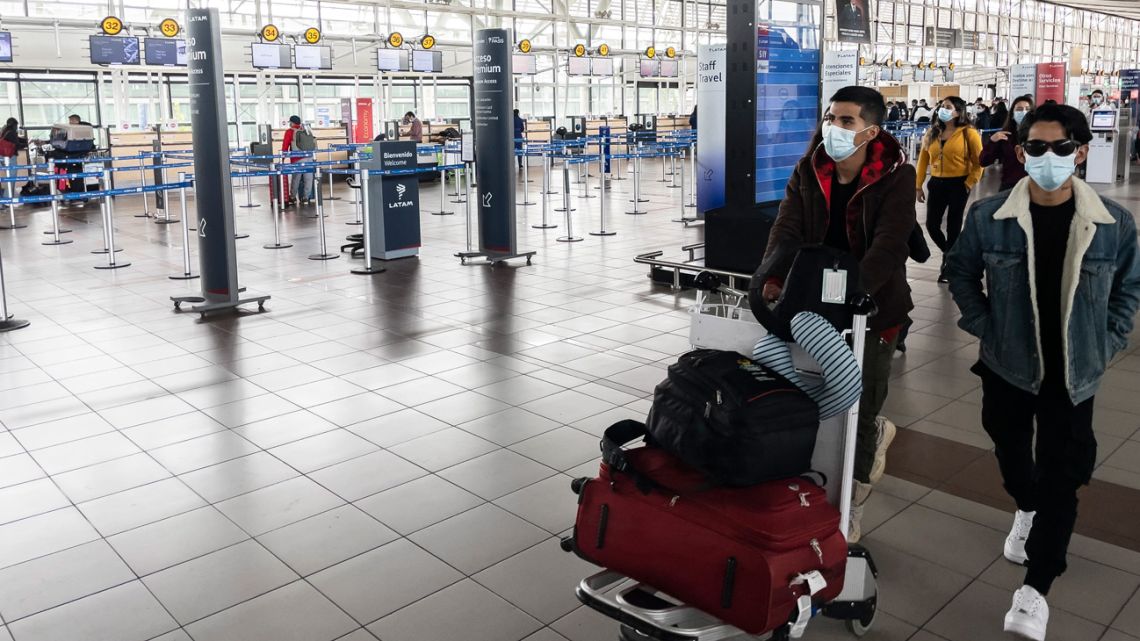 Passengers walk at Arturo Merino Benítez International Airport in Santiago on April 1, 2021, after Chile announced it will close its borders in April as of Monday amid a surge in COVID-19 cases. 