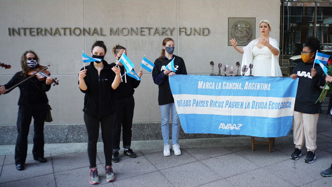 An activist dressed as Evita Perón takes part with others in a rally calling for debt reform during the virtual Spring Meetings of the World Bank and International Monetary Fund, outside of IMF headquarters in Washington DC on April 8, 2021. 