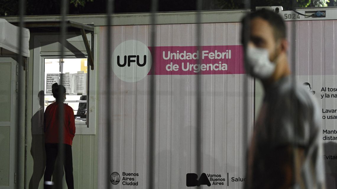 People with coronavirus symptoms queue outside a public hospital to be tested.