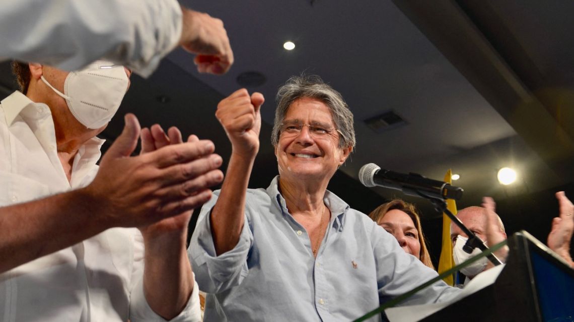 Ecuadorean President-elect Guillermo Lasso (centre) speaks to the press next to his wife María de Lourdes Alcivera (right) and ex-Guayaquil mayor Jaime Nebot as he celebrates his victory in Guayaquil, Ecuador on April 11, 2021.