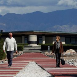 Architects Mario Yanzón (left) and Eliana Bórmida walk posing for a picture at Alfa Crux, a winery in the Uco Valley, San Carlos Department, in the Argentine province of Mendoza, on April 1, 2021. The winery was designed by the Mendoza-based Bórmida & Yanzón studio, which specialises in wine architecture and has built more than 30 wineries since 1988, many of which have received national and international awards.