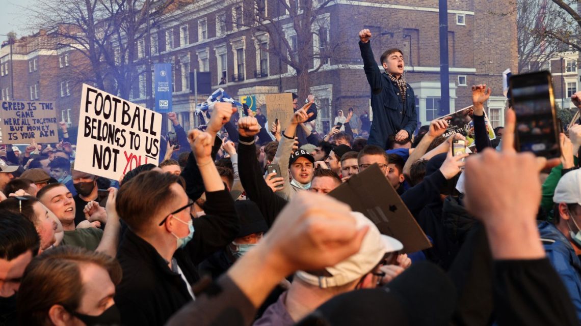 Football supporters demonstrate against the proposed European Super League outside of Stamford Bridge football stadium in London on April 20, 2021, ahead of the English Premier League match between Chelsea and Brighton and Hove Albion.