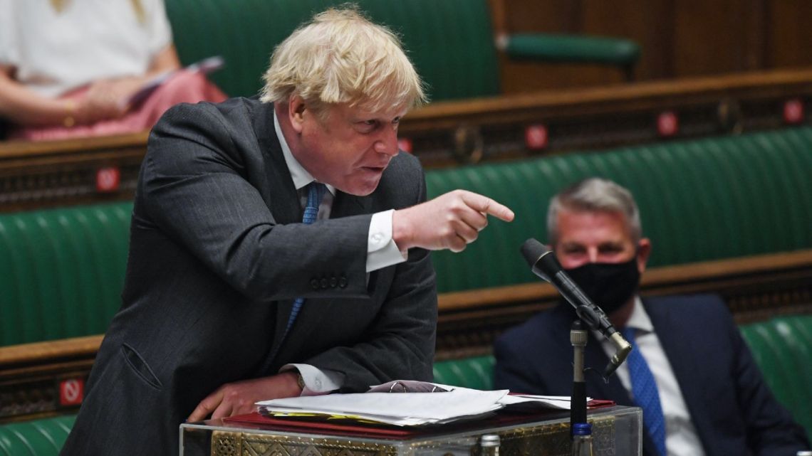 A handout photograph released by the UK Parliament shows Britain's Prime Minister Boris Johnson point at Britain's main opposition Labour Party leader Keir Starmer (unseen) during Prime Minister's Questions (PMQs) in a socially distanced, hybrid session at the House of Commons, in central London on April 28, 2021. 