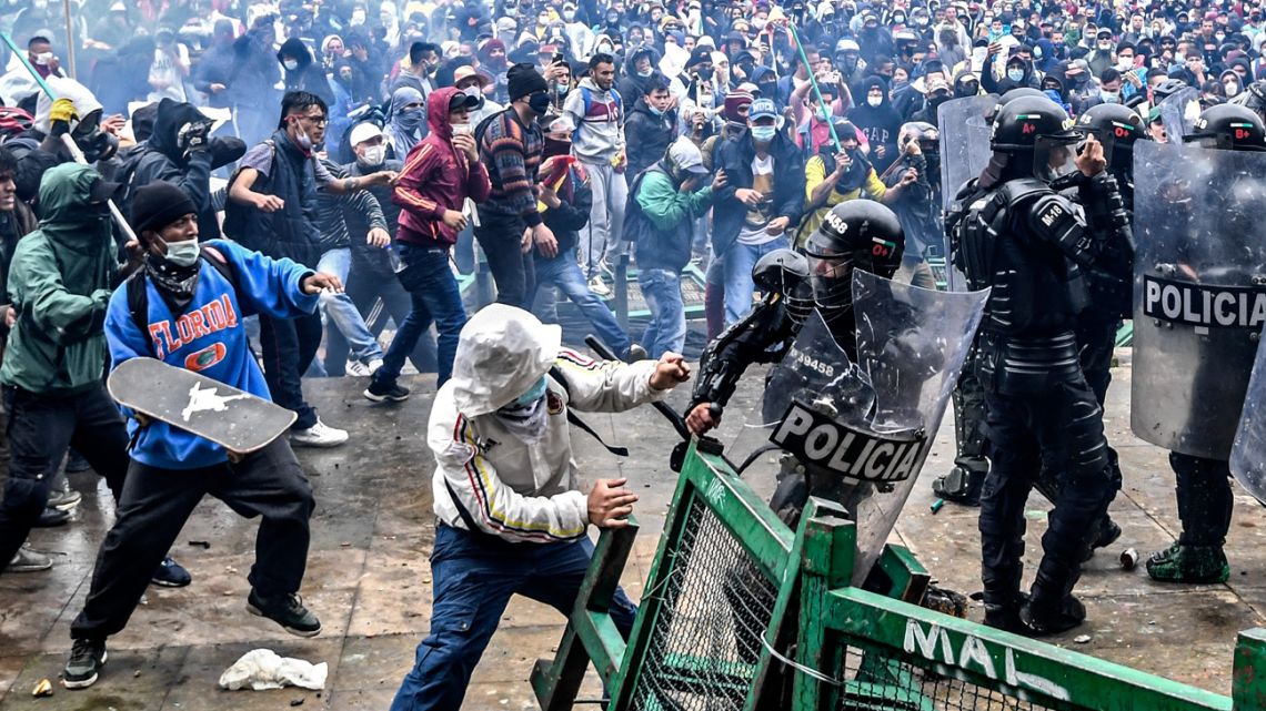 Demonstrators clash with riot police during a protest against a tax reform bill launched by Colombian President Iván Duque, in Bogotá, on April 28, 2021. 