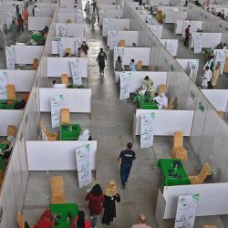 Las personas se reúnen para vacunarse con la vacuna contra el coronavirus Sinopharm Covid-19 de fabricación china en un campo de vacunación organizado en el centro de exposiciones en Lahore. | Foto:Arif Ali / AFP