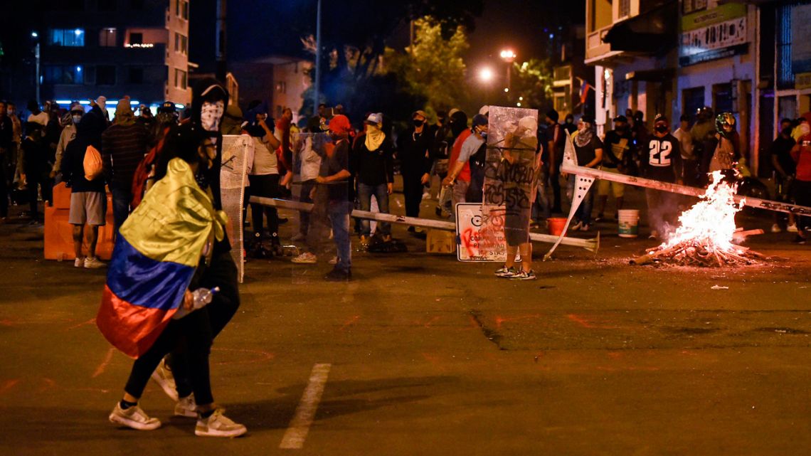 Demostrators block a street with a barricade in Cali, Colombia, on May 2, 2021, during a protest against a tax reform bill launched by President Iván Duque. 