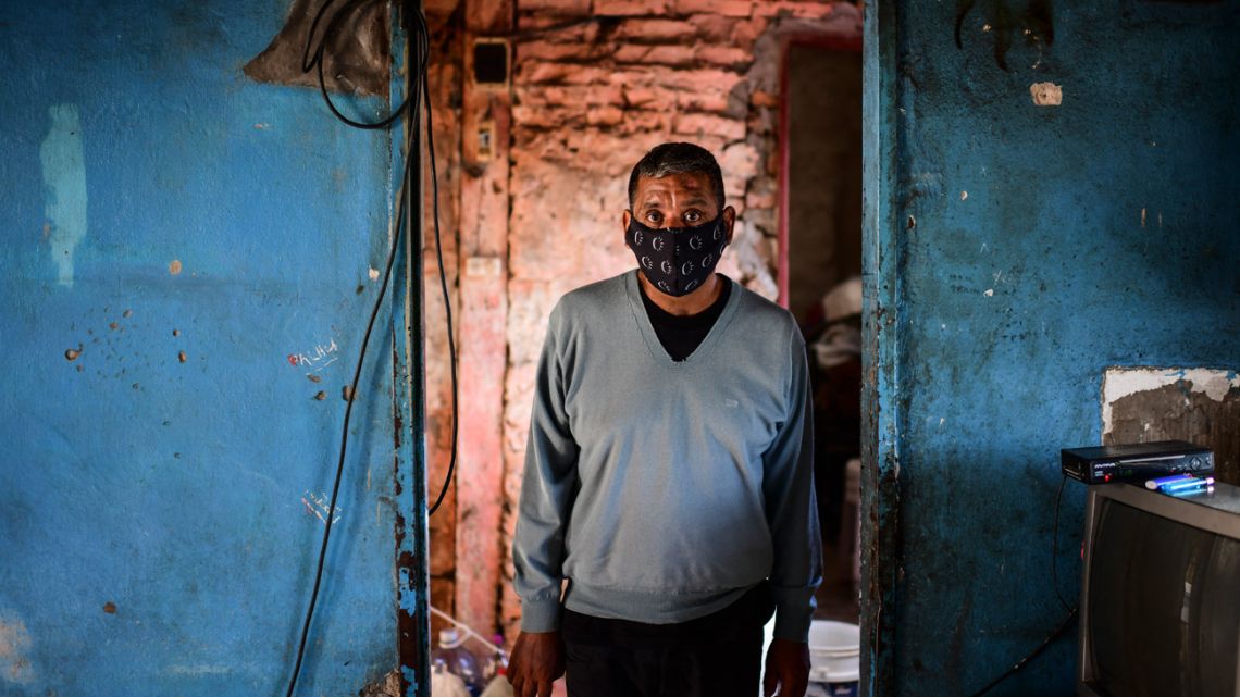 Covid-19 survivor Raúl Almirón poses for a picture at his house in Florencio Varela, Buenos Aires Province. After beating Covid-19 and spending six months in intensive care, Almirón has struggled to return to normal life, taking care of his children and going to work. 