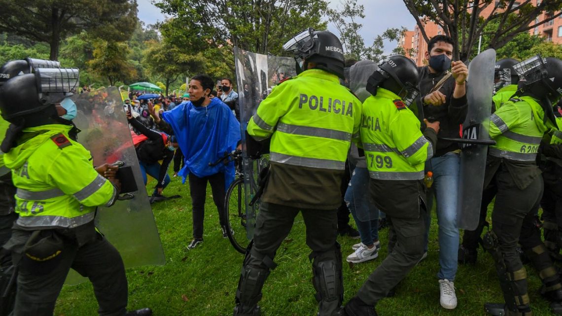Demonstrators clash with riot police during a protest near Colombian President Iván Duque's house in Bogotá on May 1, 2021. 