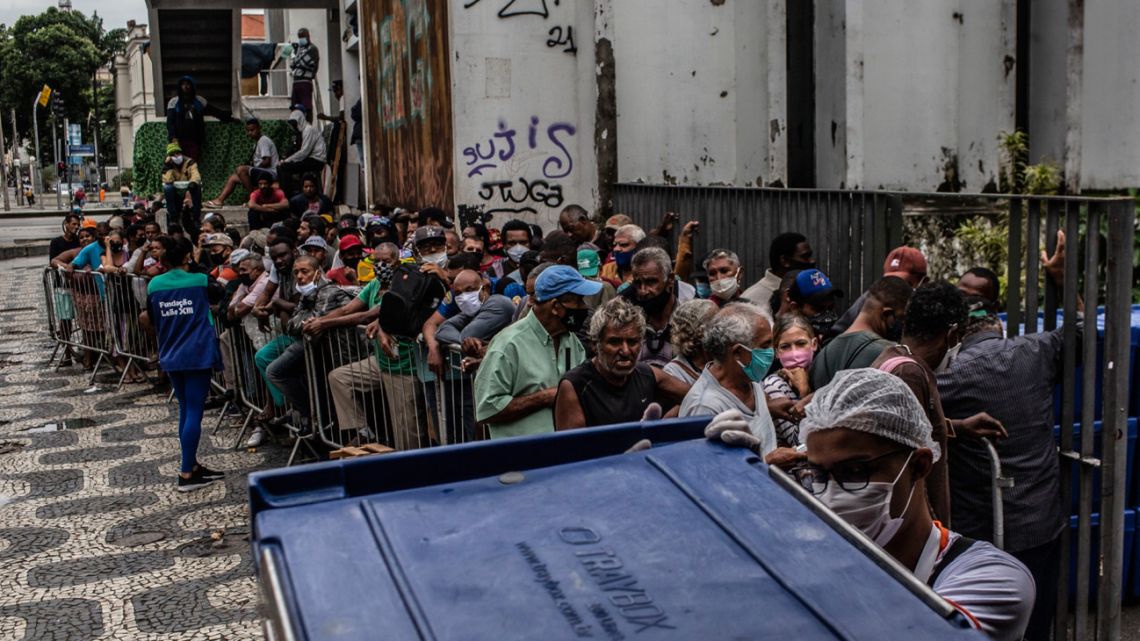 People wait to receive food outside the Biblioteca Parque Estadual in downtown Rio de Janeiro.