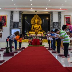 Los devotos rezan junto a una estatua para conmemorar el festival budista del Día de Vesak para conmemorar el nacimiento, la iluminación y la muerte de Buda, en la ciudad de Surabaya en Java Oriental. | Foto:Juni Kriswanto / AFP