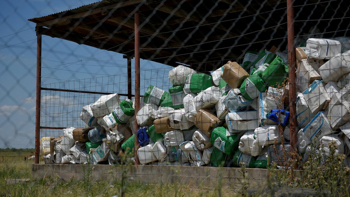 In this file photo taken on July 07, 2018 discarded agrochemical cans are seen at a depot near Gualeguaychu, Entre Rios province, Argentina. In the humid Argentine pampa, soy is healthy thanks to the good climate, the soil and the use of pesticides and fertilizers, but only 8% of empty pesticide containers are recovered and millions are illegally discarded or recycled.