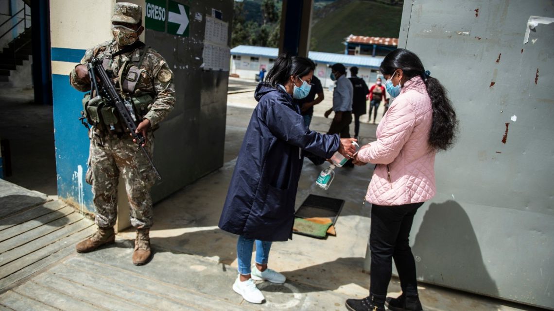 A woman arrives to a polling station during national elections in Tacabamba, Peru, on June 6, 2021. 