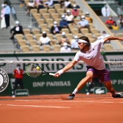 El griego Stefanos Tsitsipas devuelve la pelota al español Pablo Carreño Busta durante el partido de tenis de cuarta ronda de individuales masculinos de tenis Roland Garros 2021 del Abierto de Francia en París. | Foto:Anne-Christine Poujoulat / AFP