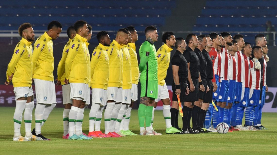 Brazil and Paraguay line up for the national anthems, ahead of their South American qualification football match for the FIFA World Cup Qatar 2022 at the Defensores del Chaco Stadium in Asunción on June 8, 2021.