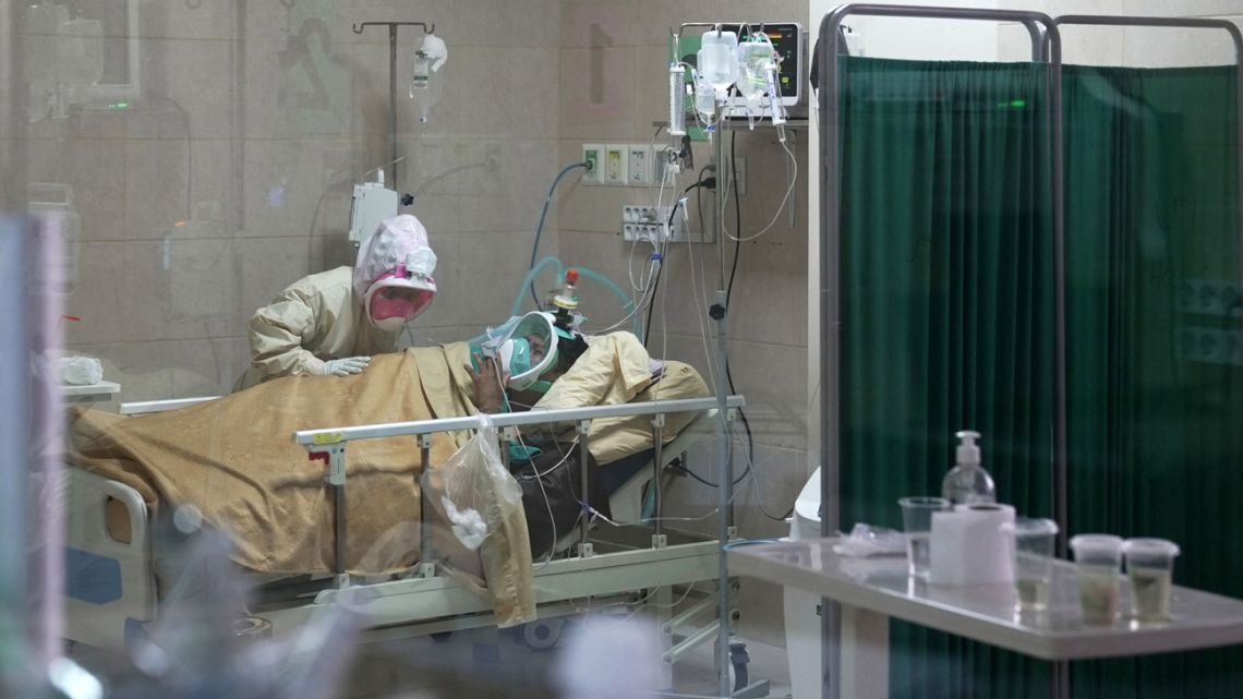 Auxiliary nurse Nicolasa Rojas, 36, treats a critical patient in the ICU unit of the Hospital del Sur in Cochabamba, Bolivia on June 1, 2021. 