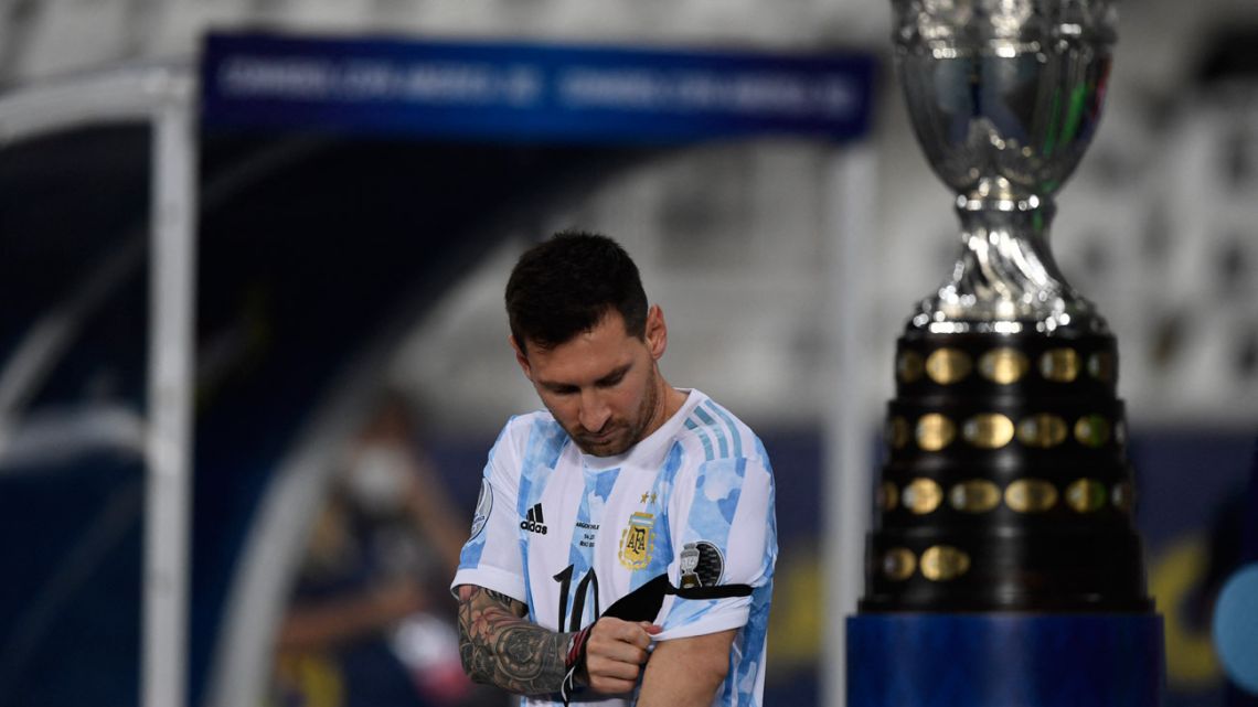 Argentina's Lionel Messi walks by Copa América trophy before the Albiceleste's clash with Chile at the Nilton Santos Stadium in Rio de Janeiro, Brazil, on June 14, 2021.