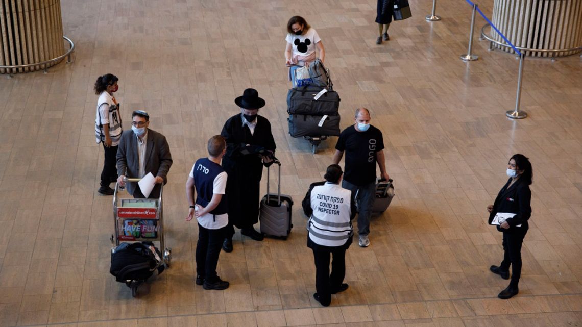 Travellers walk towards a Covid-19 testing site after landing at Ben Gurion International Airport in Tel Aviv, Israel, on Tuesday, June 22, 2021.