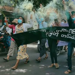 Esta foto muestra a los manifestantes sosteniendo bengalas mientras participan en una manifestación contra el golpe militar en Mandalay. | Foto:Handout / FACEBOOK / AFP